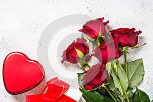 Valentines day background. Red roses, hearts and present on white.