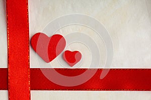 Valentines day background. Red satin ribbon and hearts.