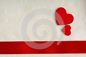 Valentines day background. Red satin ribbon and hearts.