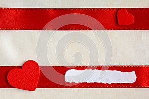 Valentines day background. Red satin ribbon and hearts.