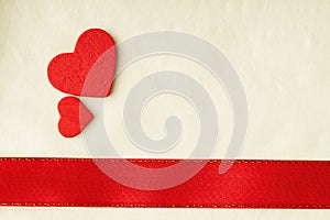 Valentines day background. Red satin ribbon and hearts.