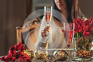 Valentines day background with roses, candles and champagne in hotel or restaurant, romantic evening