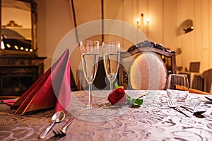 Valentines day background with roses and champagne in hotel or restaurant, romantic evening