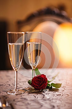 Valentines day background with roses and champagne in hotel or restaurant, romantic evening