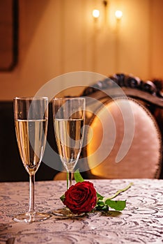 Valentines day background with roses and champagne in hotel or restaurant, romantic evening