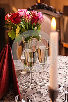 Valentines day background with roses and champagne in hotel or restaurant, romantic evening