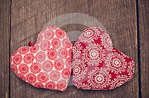 Valentines day background with two handmade toy hearts on wooden