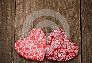 Valentines day background with two handmade toy hearts on wooden