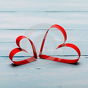 Valentines day background with two hearts on wooden background