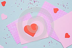 Valentines day background. Valentine card with heart and craft paper on the blue background