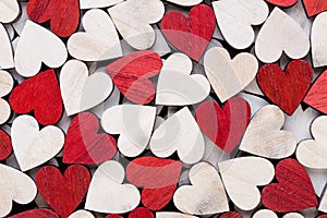 Valentines day background with white end red hearts on wooden background