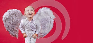 Valentines day banner with angel child. Angel child boy with white wings laughing. Excited angelic children is laugh