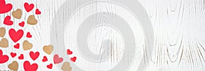 Valentines Day banner with corner border of red and wood hearts on a white wood background