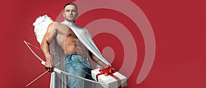 Valentines Day banner. Sexy guy with angels wings. Cupid. Amour. February 14. Arrow of love. Isolated on red. Banner