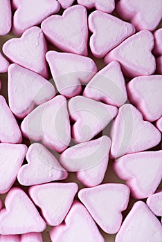 Valentines Day candy hearts marshmallows over green background