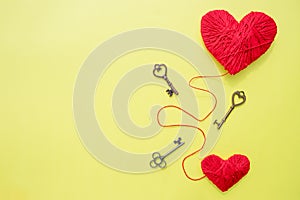 Valentines day card with red hearts and key on yellow background.Copy space.The metaphor of the key to heart. symbol