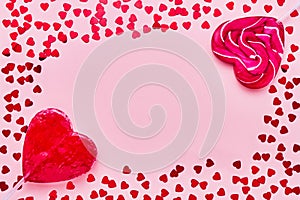 Valentines Day card. Two lollipops candy heart shape on pink background. Copy space, top view