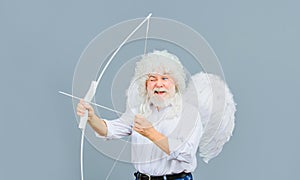 Valentines Day celebration. Happy bearded man in angel wings with bow and arrow. God of love. Valentine cupid in white