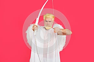 Valentines day celebration. Male cupid in angel wings shoots at target with arrow. God of love. Valentine cupid angel