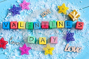 Valentines Day on colour wooden cubes On light blue background with stars. Love concept