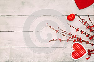 Valentines Day composition. Red hearts, gift box, on wooden background.