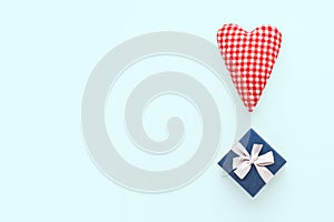 Valentines day composition. Two soft red hearts and gift box on pastel blue background. Flat lay, top view, copy space