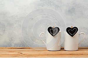 Valentines day concept with coffee cups and chalkboard heart shapes