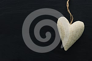 Valentines day concept. fabric heart over black background. Flat lay composition