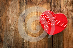 Valentines day concept. Gift box over wooden background. Flat lay composition