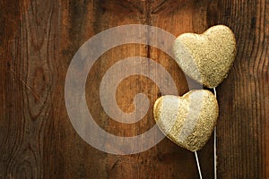 Valentines day concept. gold glitter hearts over wooden background. Flat lay composition