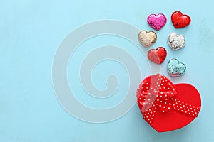 Valentines day concept. hearts and gift box over wooden blue background. Flat lay composition
