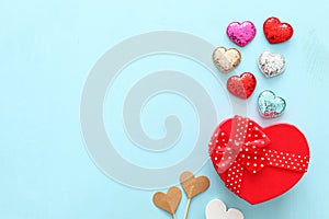 Valentines day concept. hearts and gift box over wooden blue background. Flat lay composition