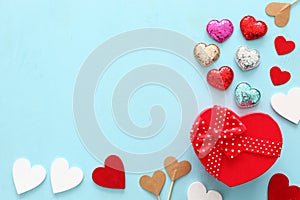 Valentines day concept. hearts and gift box over wooden blue background. Flat lay composition