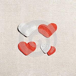 Valentines day concept, knit hearts valentine as creative square pattern, handmade colored crochet heart on cloth table