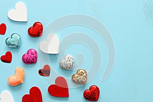 Valentines day concept. many hearts over wooden blue background. Flat lay composition