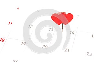 Valentines day concept. Paper red hearts pin on day 14th february at calendar