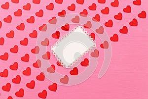 Valentines day concept. red hearts over wooden pink background. Flat lay composition