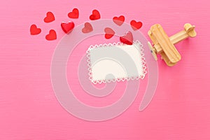 Valentines day concept. red hearts over wooden pink background. Flat lay composition