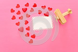 Valentines day concept. red hearts over wooden pink background. Flat lay composition