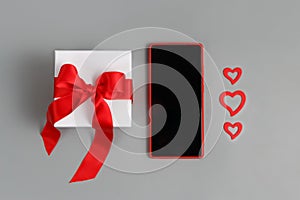 Valentines Day concept - Red Mobile phone, gift box with a bow and hearts