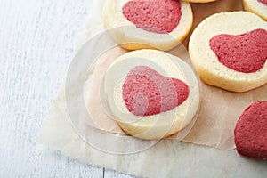 Valentines day cookies. Shortbread cookies inside a sweet red heart on parchment paper on white background. Mothers day. Womans da