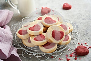 Valentines day cookies. Shortbread cookies inside a sweet red heart on pink plate on grey background. Mothers day. Womans day. Swe