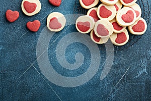 Valentines day cookies. Shortbread cookies inside a sweet red heart on parchment paper on dark blue background. Mothers day. Woman