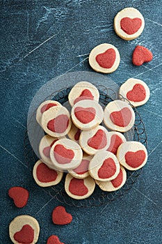 Valentines day cookies. Shortbread cookies inside a sweet red heart on parchment paper on dark blue background. Mothers day. Woman