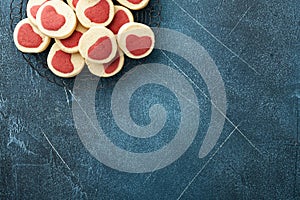 Valentines day cookies. Shortbread cookies inside a sweet red heart on parchment paper on dark blue background. Mothers day. Woman