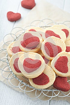 Valentines day cookies. Shortbread cookies inside a sweet red heart on parchment paper on white background. Mothers day. Womans da