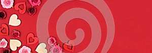 Valentines Day corner border of wooden hearts and roses on a red banner background