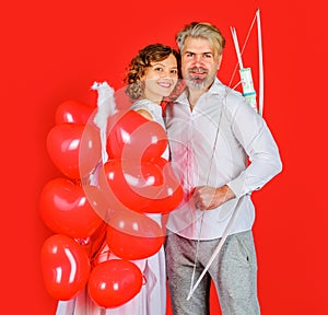 Valentines day couple. Angel with heart shape balloons. Cupid with bow and arrows. Relationships.