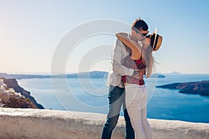 Valentines day. Couple in love kissing during honeymoon in Santorini island, Greece. People walking in Thera
