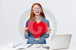 Valentines day, creativity and feelings concept. Cheerful smiling redhead girl with long-distance relatioship sending